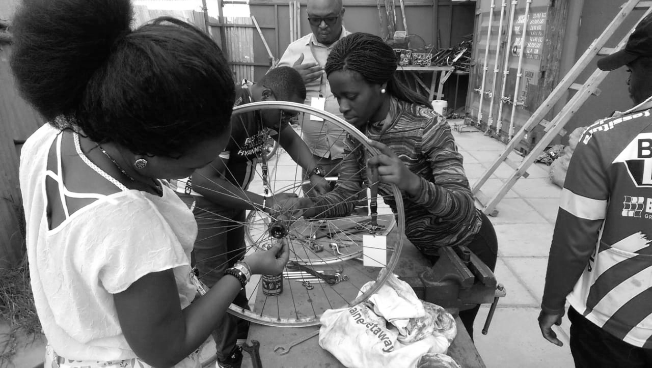 International partner, girls fixing bikes